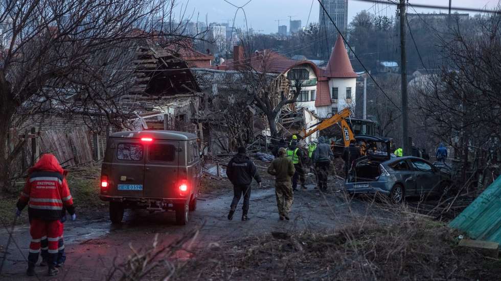 epa10384026 Medical workers, together with the police and investigators work at the site of the Russian missile attack, in Kyiv, Ukraine, 31 December 2022. Russian missiles targeted major cities across Ukraine on 31 December prior to the New Year celebration. Kyiv Mayor Vitaliy Klitschko reported explosions and destruction in three districts of the capital. At least one person was killed, Klitschko said. Russian troops entered Ukraine on 24 February 2022 starting a conflict that has provoked destruction and a humanitarian crisis.  EPA/ROMAN PILIPEY