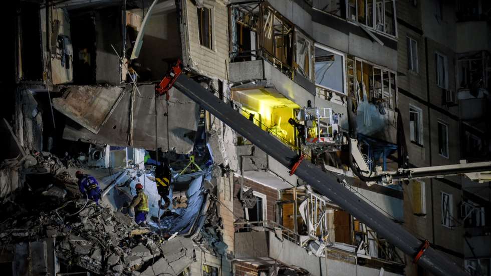 epa10407421 Rescue workers remove debris at the site of a damaged residential building in Dnipro, southeastern Ukraine, 15 January 2023, amid Russia's invasion. At least 25 people died, including one child, 73 other were injured, including 13 children, and 43 reports of missing persons were received, after a rocket hit a nine-story building in Dnipro on 14 January, the State Emergency Service (SES) of Ukraine said in a statement. Russian troops entered Ukraine on 24 February 2022 starting a conflict that has provoked destruction and a humanitarian crisis.  EPA/OLEG PETRASYUK