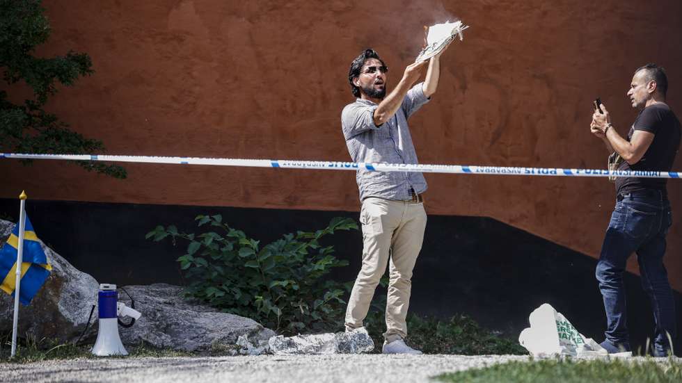 epa10715717 Salwan Momika, an Iraqi man, sets a copy of the Koran on fire outside a mosque in Stockholm, Sweden, 28 June 2023. An Iraqi man planning to burn a Koran was granted permission to do it on 28 June, after Stockholm's Court of Appeal earlier this year ruled that the police's decision to ban it in another instance was incorrect. The Leader of Danish far-right political party Hard Line had burned a copy of the Koran, sparking riots across Sweden and many Muslim countries around the world. 'The permission for today's gathering has been given out in consideration of the fact that the Court of Appeal has rejected those decisions,' police spokesperson Helena Bostrom Thomas told TT.  EPA/STEFAN JERREVANG EDITORS NOTE: THE CONTENT OF THIS IMAGE MAY HURT RELIGIOUS SENTIMENTS SWEDEN OUT