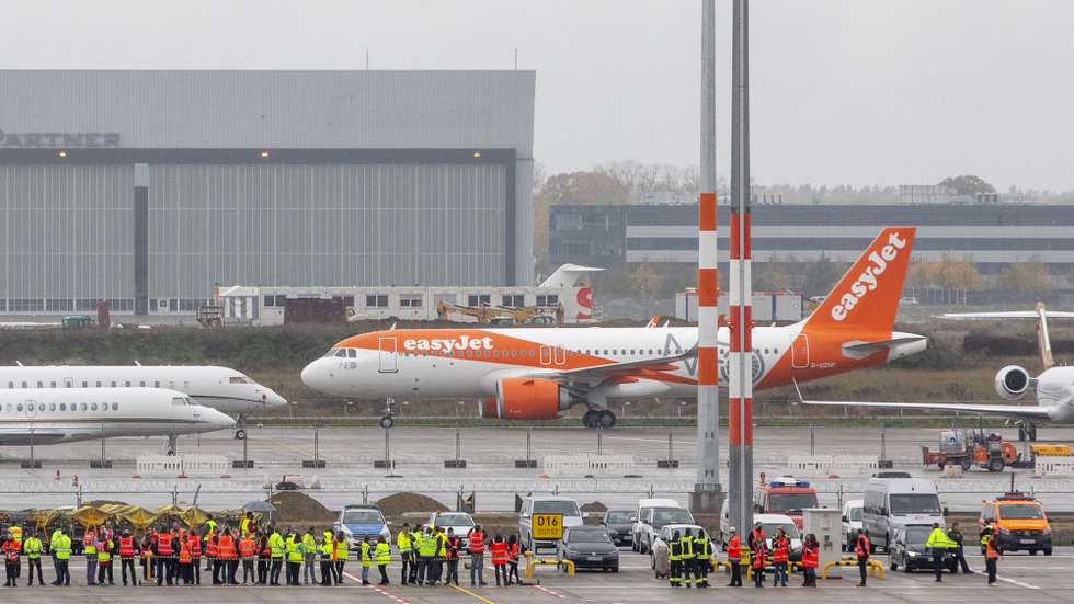 epa08788742 Aircraft of airline Easyjet arrives at Berlin's airport "Berlin Brandenburg Airport Willy Brandt", during the opening on the first day of operation for the new BER Berlin Brandenburg Airport on October 31, 2020 in Schoenefeld, Germany. The new airport incorporates former Schoenefeld airport as its Terminal 5 and also replaces Tegel Airport, which will close in coming days. Berlin Brandenburg Airport was originally scheduled to open in 2011 but was stricken by design flaws, corruption scandals, legal wranglings and failed technical audits. The airport will serve Berlin and the surrounding region.  EPA/Maja Hitij / POOL