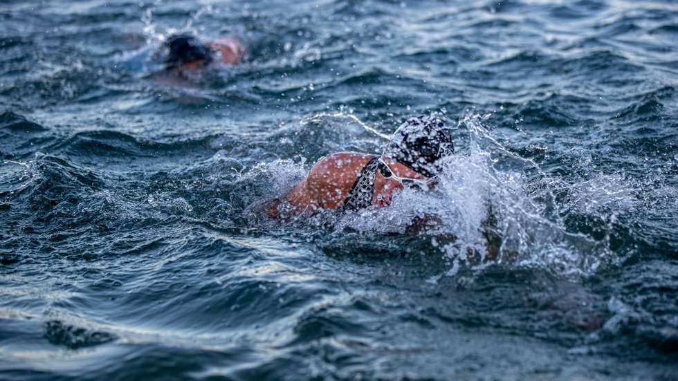 epa09414688 Athletes in action during the Swimming Race of the Ironman European Championship 2021 at Forest Lake Langen near Frankfurt am Main, Germany, 15 August 2021.  EPA/Constantin Zinn