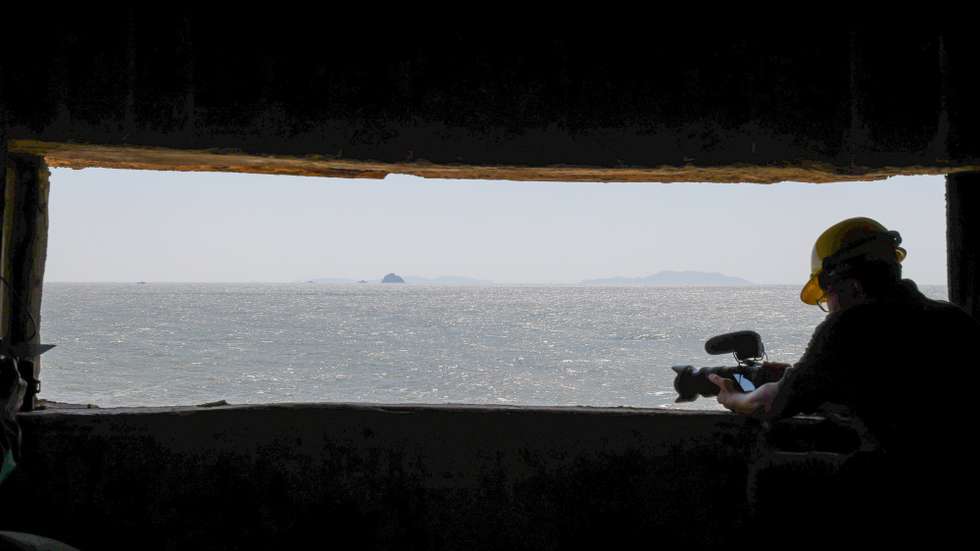 epa10914403 A man film from a window inside one of the 26 old military wartime tunnels during the Matsu Biennial art exhibition in Nangan, Matsu Islands, Taiwan, 12 October 2023. Matsu Biennial showcases local artists' creative perspectives on the island through an 'island perspective' project at Chungshan Gate on Nangan Island. The exhibition, reinterpreted as an arts and culture venue, aims to launch Matsu's arts and culture internationally, marking the first significant exhibition since Chungshan Gate's transformation. The Matsu Islands, a group of 36 islands in the East China Sea, are the smallest county in Taiwan.  EPA/RITCHIE B. TONGO