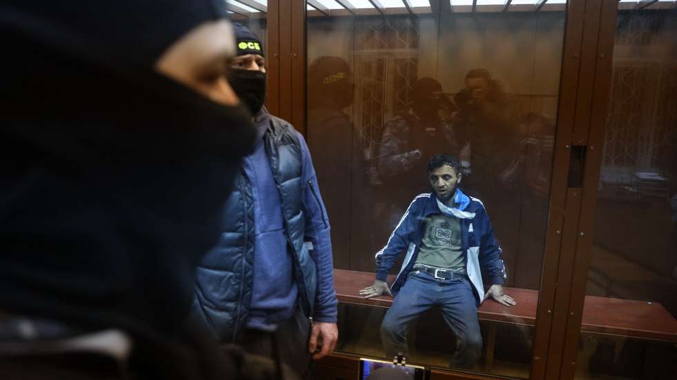 epa11241602 A suspect in the shooting attack on the Crocus City Hall concert venue sits inside a defendant's enclosure during a hearing on pretrial restrictions at Basmanny district court, in Moscow, Russia, 24 March 2024. At least 137 people were killed and more than 100 hospitalized after a group of gunmen attacked the concert hall in the Moscow region on 22 March evening, Russian officials said. Eleven suspects, including all four gunmen directly involved in the terrorist attack, have been detained, according to Russian authorities.  EPA/SERGEI ILNITSKY