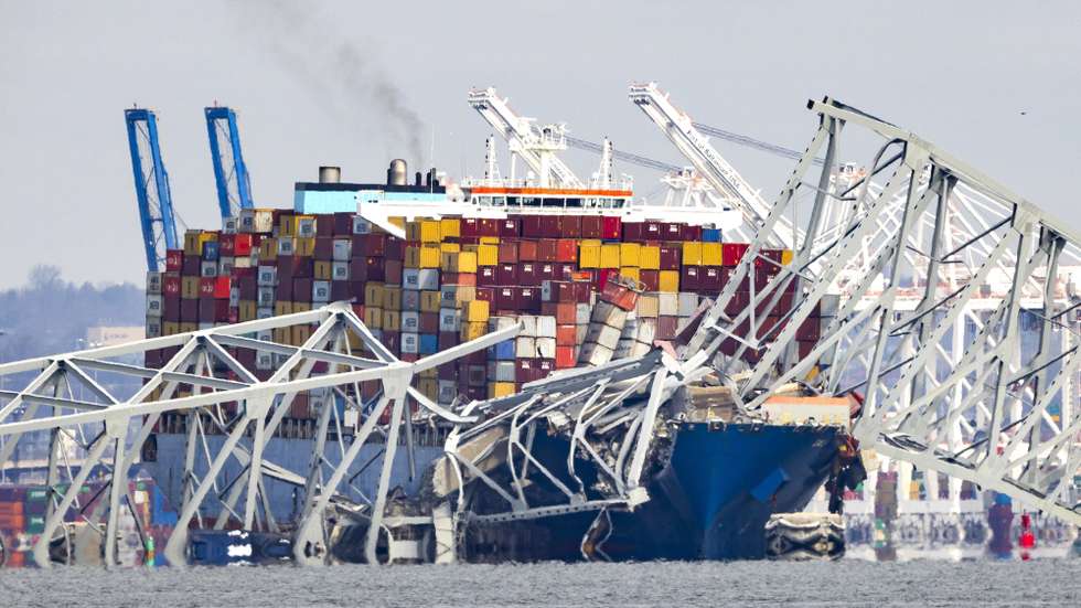 epa11244639 The Francis Scott Key Bridge rests partially collapsed after a cargo ship ran into it in Baltimore, Maryland, USA, 26 March 2024. The Maryland Department of Transportation (MDOT) confirmed that the Francis Scott Key Bridge collapsed due to a ship strike on 26 March. Two people were rescued while at least six others were still missing, the MDOT Secretary said in a press conference, adding that they are believed to be members of a construction crew working on the bridge at the time of the incident.  EPA/JIM LO SCALZO