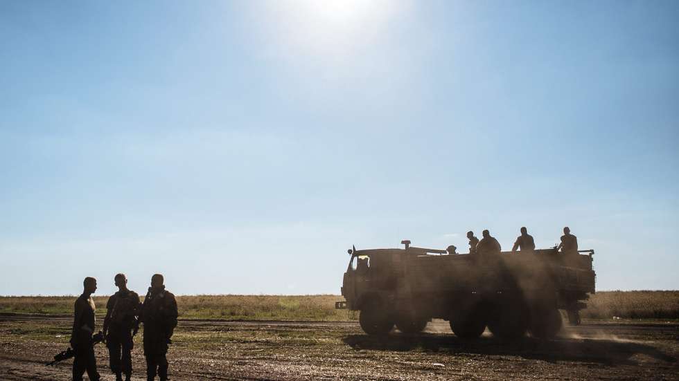 epa04361718 Ukrainian soldiers drive on a truck close to their military camp near Luhansk, Ukraine, 20 August 2014. The Ukrainian town of Makeyevka and different suburbs of Donetsk have been shelled all day by Ukranian army, during which allegedly ten children were killed in a kindergarden in Makeyevka, the self-proclaimed leadership of Donetsk People's Republic reported. Russian President Vladimir Putin and Ukrainian President Petro Poroshenko will meet for talks next week in Belarus, the Kremlin said 19 August, raising hopes for a political solution to the bloodshed in eastern Ukraine.  EPA/ROMAN PILIPEY