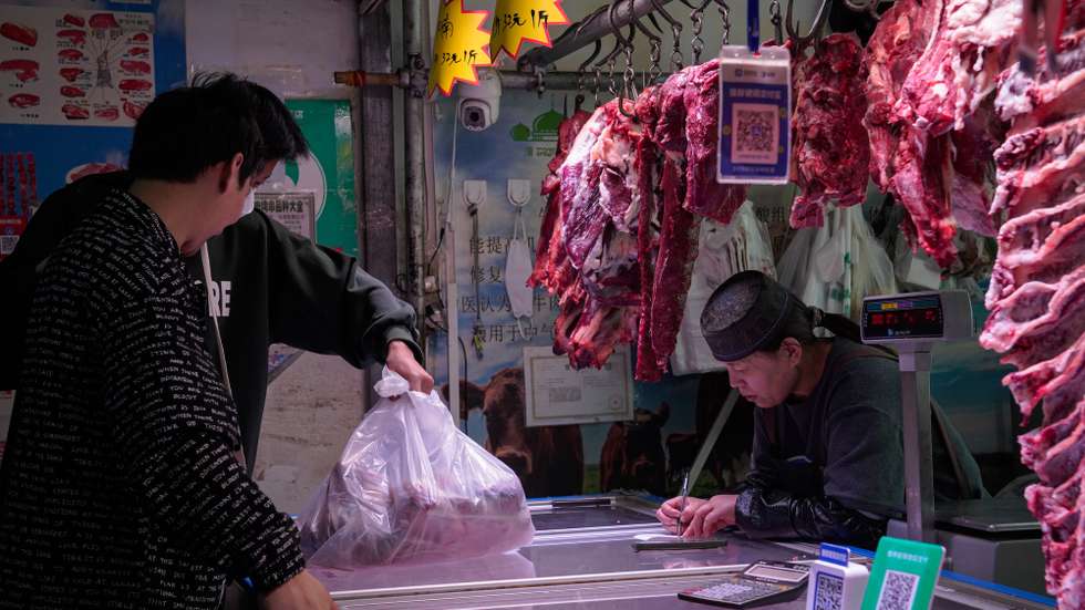 epa11332412 People buy food at a meat shop in a market in Beijing, China, 11 May 2024. According to the report by the National Bureau of Statistics on 11 May, China's Consumer Price Index (CPI) stood at 0.3 percent year on year in April 2024.  EPA/WU HAO