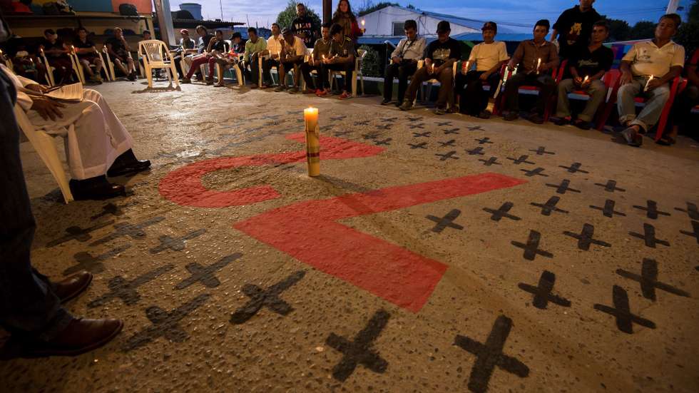 epa07783387 Central American migrants pray during the anniversary of the 2011 San Fernando massacre, at the Migrant House in Saltillo, Mexico, 20 August 2019. A total of 72 people were allegedly killed during the 2011 massacre by 'Los Zetas' cartel with the complicity of the local police on 22 August 2010.  EPA/MIGUEL SIERRA