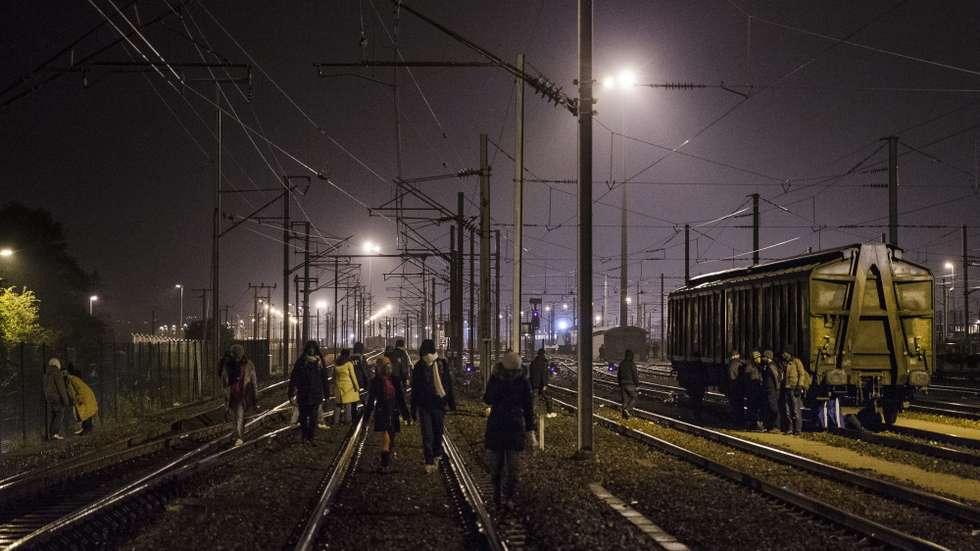epa04979111 Migrants walk along the railway as they try to catch a train to reach England, in Calais, France, 15 October 2015. Dozens of minor breaches of security cordons are reported nightly, Eurotunnel has said. The company and French police tightened security in July and August after the number of refugees trying to force their way towards the tunnel had risen to some 2,000 nightly in June. Eurotunnel said it had intercepted 37,000 refugees this year by the end of July, while more than a dozen people have died during recent attempts to find a way through the tunnel. Many refugees live for months in crude encampments around Calais as they await a chance to reach Britain.  EPA/YOAN VALAT