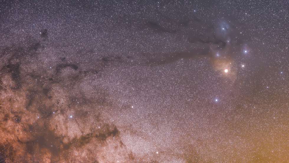 epa09987402 A rendered timelapse image shows red supergiant Antares next to Rho Ophiuchi nebula's three stars (R) and 'Rio Negro' dark star dust near of the Wilky Way and taken from La Lora wasteland in Cantabria, Spain, early 31 May 2022.  EPA/Pedro Puente Hoyos
