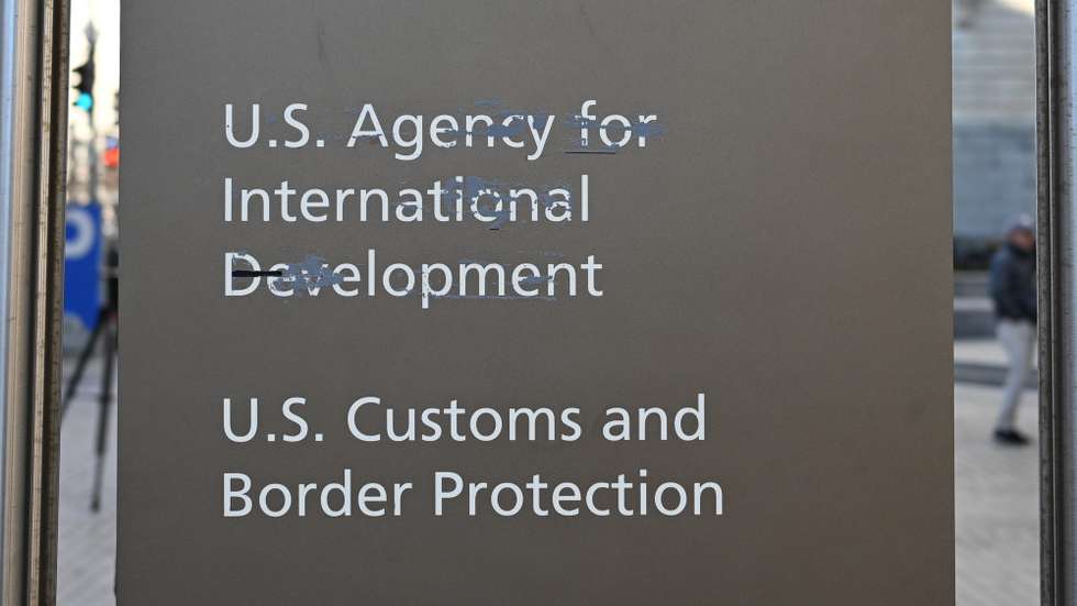epa11881540 Residue from tape that was removed covers the print of the letters of the US Agency for International Development (USAID) at its headquarters in Washington, DC, USA, 07 February 2025. Following the Trump administration reorganization plans, spearheaded by billionaire Elon Musk, around 300 members were expected to remain out of the USAID's worldwide total of more than 10,000.  EPA/ALEX WROBLEWSKI