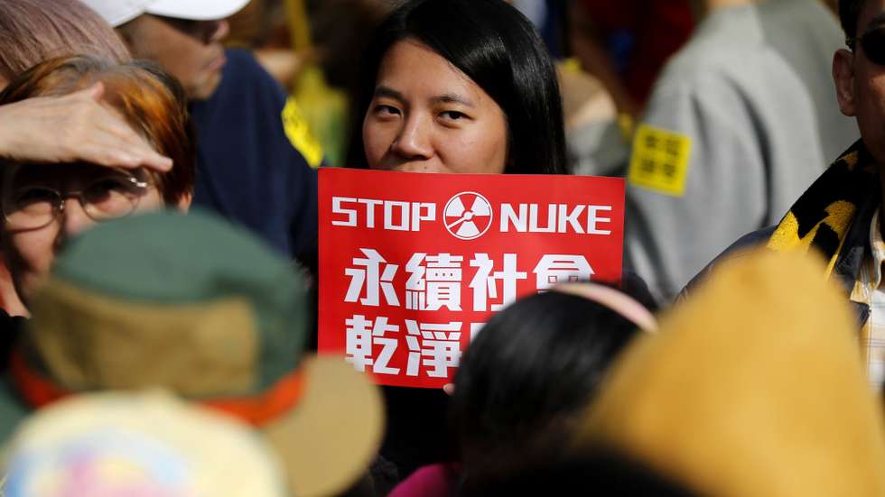 epa05841966 Taiwanese protesters carry anti-nuclear power plant placards as they march at the street during a protest in Taipei, Taiwan, 11 March 2017. Protesters urged the Taiwanese government to shut nuclear power plants, properly dispose of nuclear waste, and promote green-energy.  EPA/RITCHIE B. TONGO