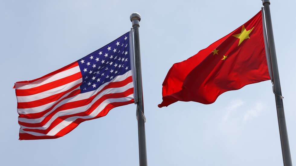 epa12293338 National flags of the United States and China are seen in front of the General Electric Science Park in Beijing, China, 11 August 2025. 12 August marks the deadline for the 90-day extension of the truce about the reciprocal tariffs between the US and China.  EPA/WU HAO