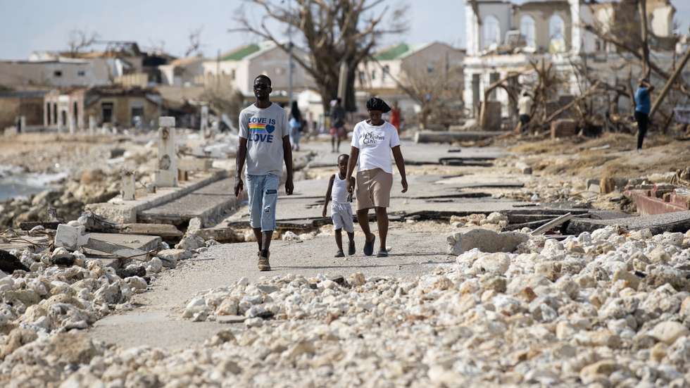 epa12496493 People walk along a street destroyed by Hurricane Melissa in Black River, Jamaica, 31 October 2025. More than 50 people have died in the Caribbean as a result of the hurricane, mainly in Haiti and Jamaica, where rescue teams are struggling to reach the most severely affected and isolated areas.  EPA/ORLANDO BARRIA