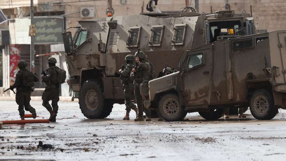 epa12614351 Israeli troops during a military operation in the Palestinian village of Qabatiya, near the West Bank city of Jenin, 27 December 2025. Israeli troops started a military operation after a  Palestinian from Qabatiya vilage killed two Israelis in a stabbing and car-ramming attack in northern Israel on December 26. Israeli forces have continued their operation against Qabatiya for the second consecutive day, imposing a tight siege accompanied by mass filed interrogations of dozens of residents, forced displacement, widespread home raids and searches, and massive destruction of infrastructure.  EPA/ALAA BADARNEH