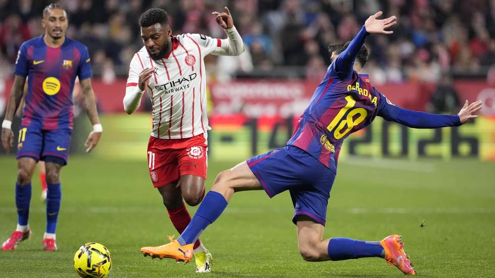 epa12748328 FC Barcelona's Gerard Marti (R) in action against Girona's Thomas Lemar (C) during the Spanish LaLiga soccer match between Girona FC and FC Barcelona, in Girona, Spain, 16 February 2026.  EPA/David Borrat