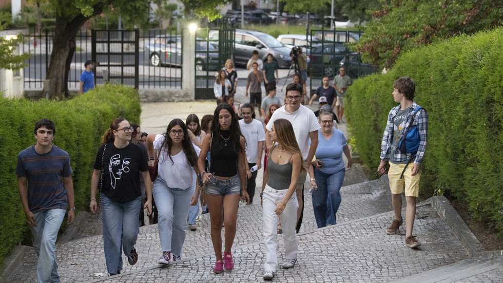 Estudantes à chegada para consultarem as pautas com as notas das provas finais do 11.º e 12.º ano, na escola secundária José Gomes Ferreira, em Lisboa, 17 de julho de 2026. Devido às dificuldades informáticas no processo de classificação eletrónica, que “pressionaram o cumprimento do calendário inicialmente previsto”, o Ministério da Educação, Ciência e Inovação decidiu ajustar o calendário da avaliação externa para garantir aos alunos a qualidade e o rigor do processo e assegurar aos professores o tempo necessário e adequado para a classificação dos itens das provas. ANTÓNIO COTRIM/LUSA