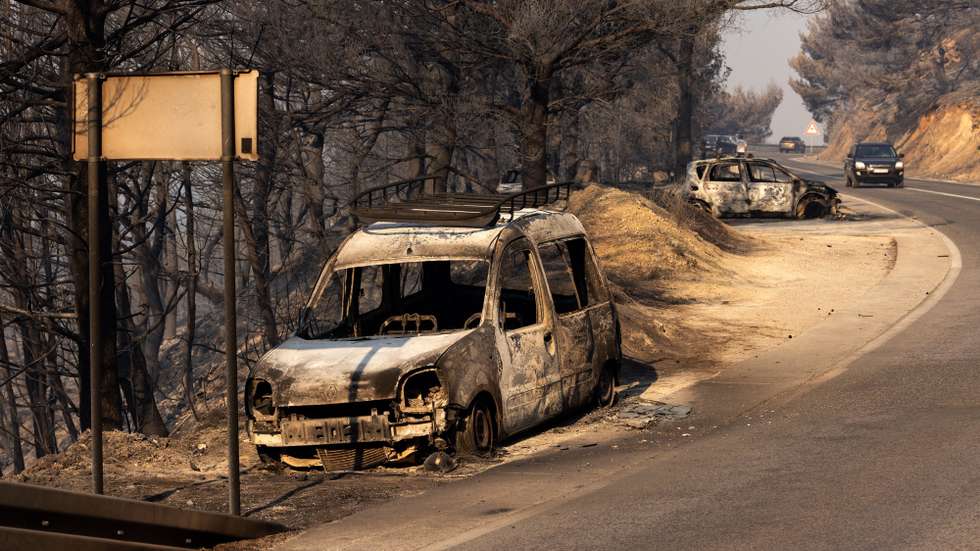 epa13168747 Burnt-out cars are seen on a road after a wildfire near the town of Omis, Croatia, 14 August 2026. Wildfires across the region have forced the evacuation of around 2,000 residents, with at least seven people being treated for life-threatening injuries.  EPA/STRINGER