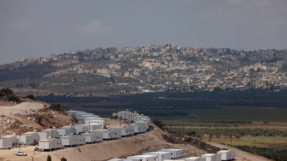 epa13204608 The new Israeli settlement 'Dotan Valley', as seen from Arraba whilst Israeli bulldozers uproots olive trees from Palestinian farms in Araba village near the west bank city of Jenin, 01 September 2026. According to Wafa Agency  Israeli forces uprooted dozens of olive trees along the road connecting the towns of Arraba and Ya'bad, southwest of Jenin. Israeli authorities had issued notices to landowners in the area to uproot olive trees, including large, old trees and small trees, as part of measures that the occupation authorities claimed were related to "securing roads and protecting the movement of settlers."  EPA/ALAA BADARNEH