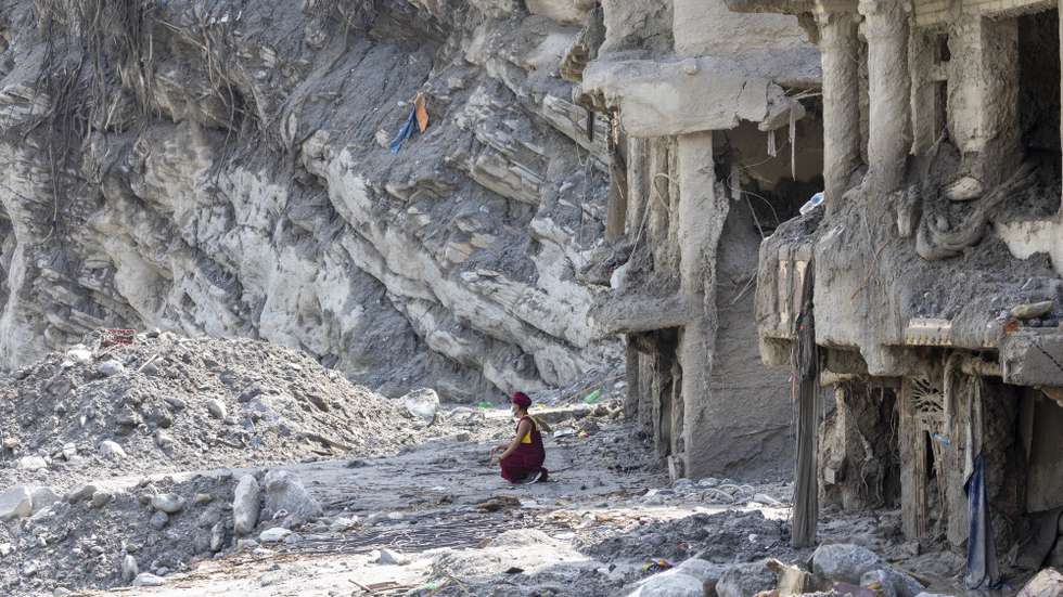 epaselect epa13218953 A Buddhist monk crouches in front of a house damaged by flash floods as he performs a 13th-day ritual in Dhunge, Nuwakot district, Nepal, 07 September 2026. Nepal is observing a national day of mourning on the 13th day following devastating flash floods. More than 1,200 people have been killed, and over 4,000 remain missing across northern Nepal after a glacial collapse and avalanche-triggered flash floods and mudslides along the Bhotekoshi and Trishuli river valleys near the Nepal-Tibet border, causing widespread destruction to settlements and infrastructure, according to the National Disaster Risk Reduction and Management Authority (NDRRMA).  EPA/NARENDRA SHRESTHA
