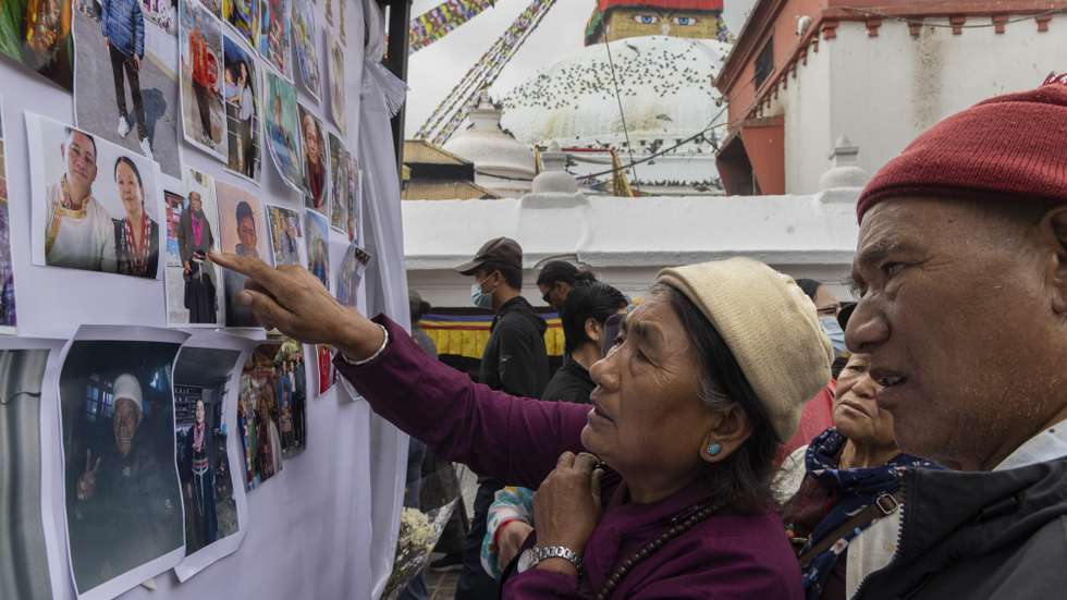 epa13242961 Family members look at photographs of people who lost their lives in flash floods that struck near the Nepal-Tibet border, during a condolence prayer meeting for those who died in the Bhotekoshi flash floods, at Boudhanath Stupa in Kathmandu, Nepal, 16 September 2026. Hundreds of Buddhist monks and family members of victims attended the three-day condolence prayer meeting, organized to pray for the souls of those who died in the disaster. More than 5,000 people remain missing and at least 1,300 people have been killed in floods triggered by a glacial collapse near the Nepal-Tibet border, according to the National Disaster Risk Reduction and Management Authority (NDRRMA).  EPA/NARENDRA SHRESTHA