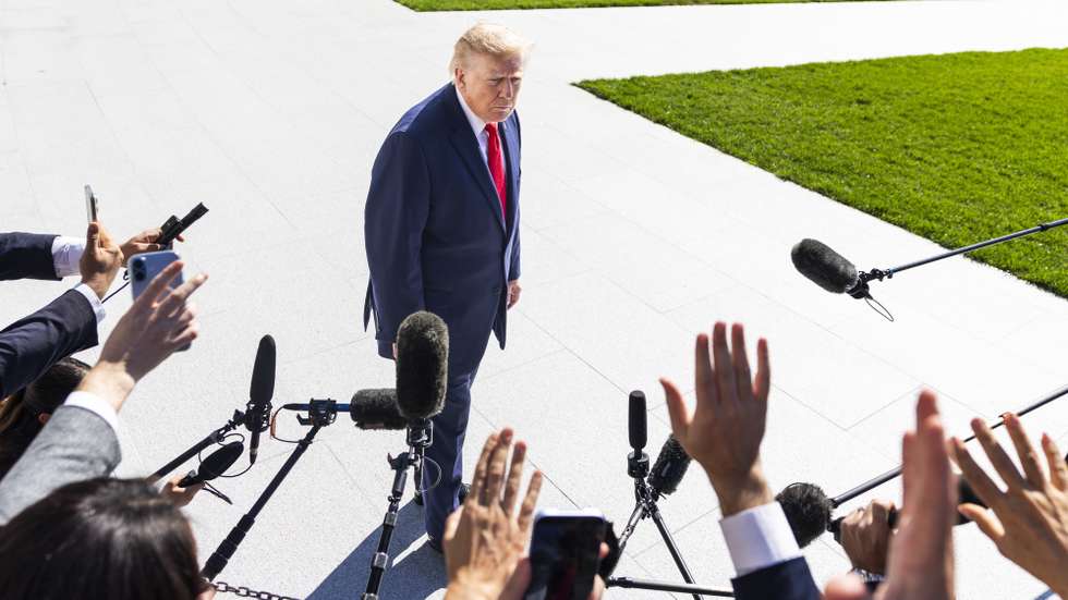 epa13300719 US President Donald Trump (C) speaks to reporters as he departs the White House for Alaska, in Washington, DC, USA, 13 October 2026. President Trump is traveling to Alaska to campaign for incumbent Republican Senator Dan S. Sullivan, who is running for re-election in November 2026.  EPA/JIM LO SCALZO