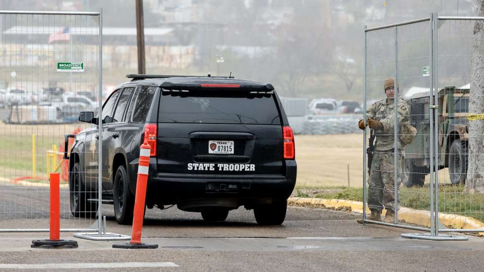 epa11076934 National Guardsmen let a Texas Department of Safety (DPS) vehicle pass through a gate of the Shelby Park in Eagle Pass, Texas, USA, 14 January 2024. The Texas Military Department confirmed that the Texas National Guard seized control of the Shelby Park in Eagle Pass, and is restricting Border Patrol from accessing the area. US Rep. Henry Cuellar said on social media that the Texas Military Department and Texas National Guard 'did not grant access to Border Patrol agents to save a group of migrants in distress attempting to cross Rio Rio Grande' on the night of 12 January.  EPA/ADAM DAVIS
