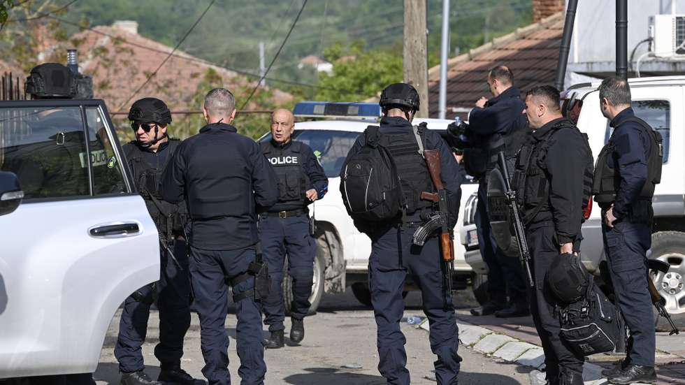 epa10656896 Kosovar police officers secure the area near the municipal building in Zvecan, Kosovo, 27 May 2023. At least ten people were injured in violence between Kosovo police and Serbs in the town of Zvecan on 26 May, as protesters gathered outside state buildings while Albanian mayors were heading to assume office.  EPA/GEORGI LICOVSKI