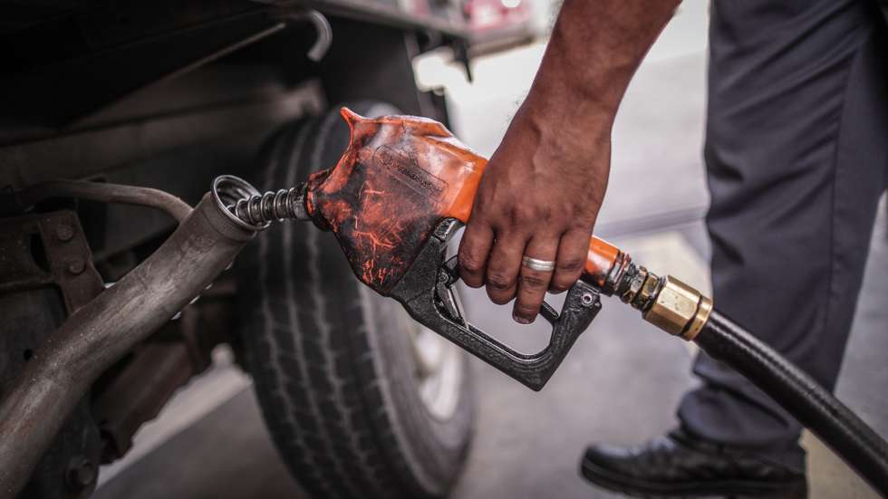 epa09496217 An employee supplies fuel to a truck, in Rio de Janeiro, Brazil, 29 September 2021. The Petrobras company confirmed on 29 September that it readjusted diesel prices at refineries by 8.89 percent with immediate effect.  EPA/ANDRE COELHO