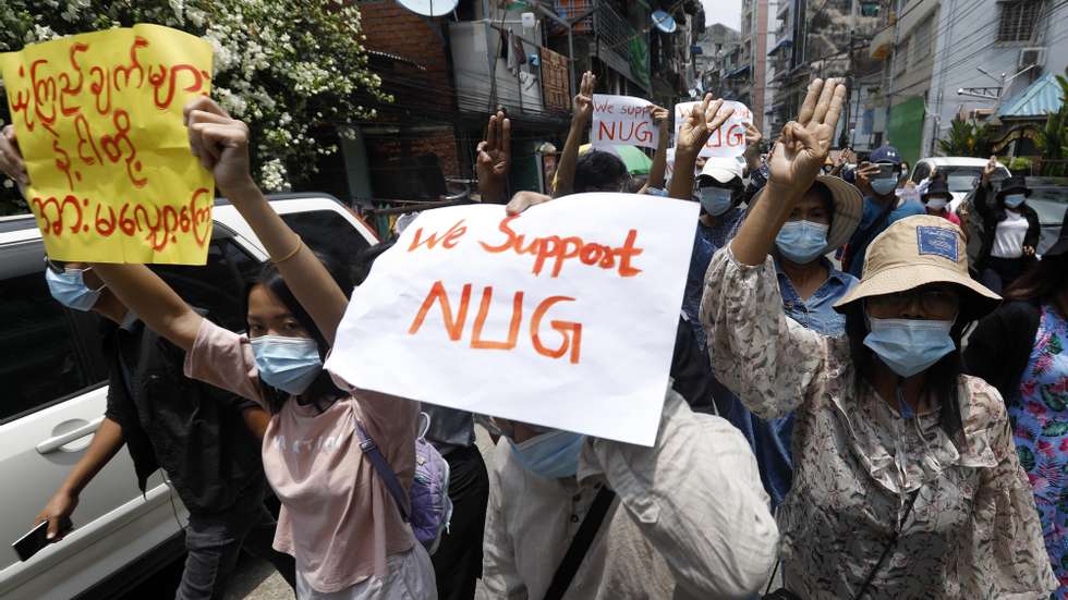 epa09162909 Demonstrators hold placards and flash three-fingers salute during an anti-military coup protest in Yangon, Myanmar, 27 April 2021. Myanmar activists have criticized the agreement between the junta leader and Association of Southeast Asian Nations (ASEAN) leaders after an emergency summit and have vowed to continue protests.  EPA/STRINGER