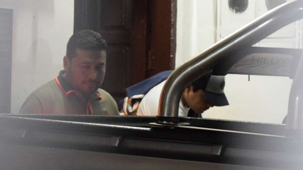 epa12460484 Marcelo Arce Mosqueira (R), son of Bolivian President Luis Arce, gets in a police car after being arrested following a complaint of domestic violence, Santa Cruz, Bolivia, 16 October 2025. The president's son appeared voluntarily to testify, accompanied by his lawyer, at which point the arrest warrant was executed.  EPA/JUAN CARLOS TORREJON