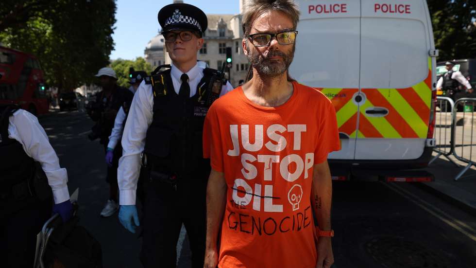 epaselect epa12233806 A Palestine Action supporter is arrested during a demonstration at Parliament Square in London, Britain, 12 July 2025. Protesters demonstrated calling for de-proscription of Palestine Action after the UK government banned the protest group and proscribed them as a terrorist group.  EPA/ANDY RAIN