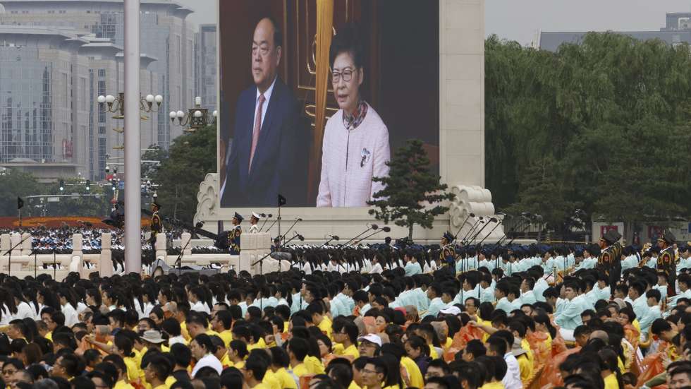 epa09314556 Hong Kong Chief Executive Carrie Lam Cheng Yuet-ngor and Macau Chief Executive Ho Iat-seng are seen on an LED monitor as Chinese President Xi Jinping (not seen) delivers his speech at Tiananmen Square during the celebration of the 100th founding anniversary of the Chinese Communist Party, in Beijing, China, 01 July 2021. China celebrates on 01 July the 100th anniversary of the founding of the ruling Chinese Communist Party.  EPA/ROMAN PILIPEY