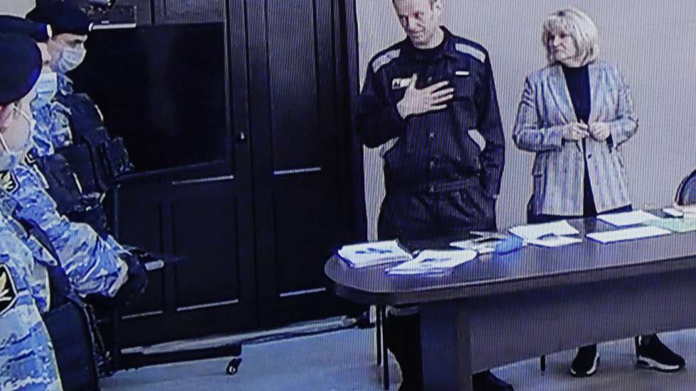 epa09842104 Russian opposition leader and activist Alexei Navalny (C) and his lawyer Olga Mikhailova (R) are seen on a monitor screen during an offsite court session in the penal colony N2 (IK-2) in Pokrov, Vladimir region, Russia, 22 March 2022. The Lefortovo Court of Moscow, at an offsite hearing in correctional colony 2, on March 22 announced the verdict against Russian opposition leader Alexei Navalny in the case of fraud and insulting the court. The founder of the Anti-Corruption Foundation, Alexei Navalny, was poisoned in the summer of 2020 and taken to Berlin for treatment, from where he flew to Moscow in January 2021. Immediately upon his return to Russia, he was detained and arrested. Since March 2021, he has been in a colony in the city of Pokrov, Vladimir Region.  EPA/YURI KOCHETKOV