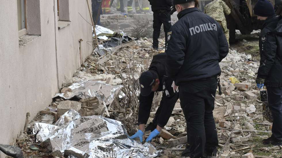 epa12432167 Ukrainian policemen cover bodies of victims at the site of a Russian strike in the Lapoivka village near Lviv, Western Ukraine, on the night of 05 October 2025, amid the ongoing Russian invasion. According to the State Emergency Service report, at least five people died and dozens were injured after Russia launched an overnight attack on Ukraine with more than 50 missiles of different types and 500 shock drones. The Lviv, Ivano-Frankivsk, Zaporizhia, Chernihiv, Sumy, Kharkiv, Kherson, Odesa, and Kirovohrad regions experienced a massive combined attack overnight.  EPA/MYKOLA TYS