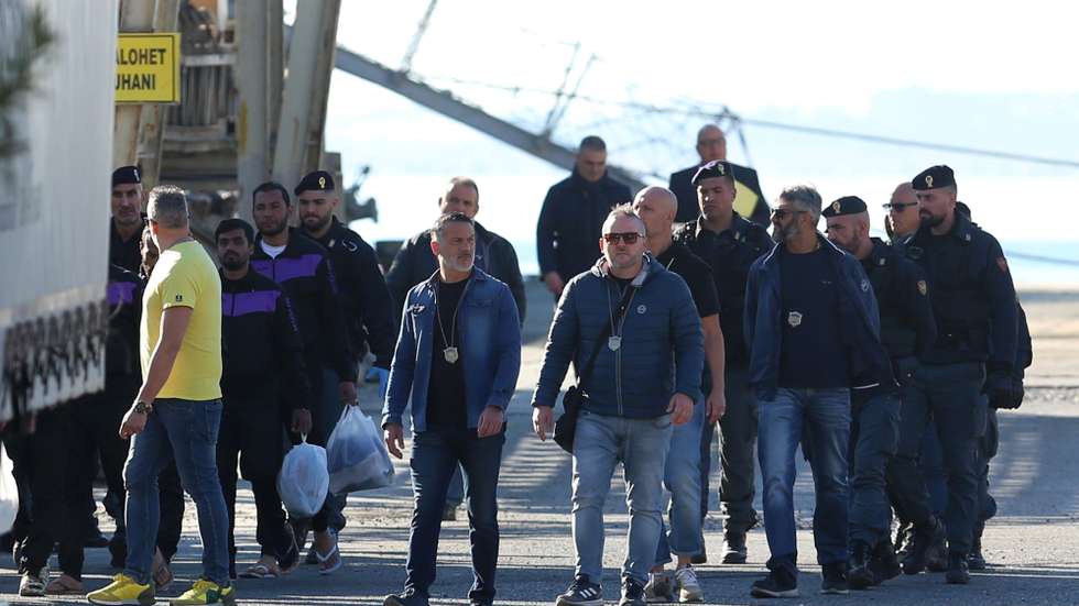 epaselect epa11709512 A group of migrants (L) intercepted in international waters around Italy, disembark the Italian Navy vessel Libra at Shengjin, Albania, 08 November 2024. Italy has sent a group of 8 migrants to Albania, after a previous group was turned away in October for failing the vetting process, in a plan aimed at deterring dangerous sea crossings by processing asylum claims outside the EU. The initiative faced legal setbacks after Italian courts ruled that migrants could not be held in Albania due to concerns over their legal status. In response, the Italian government adjusted the legal framework, hoping this would strengthen the policy, which allows up to 3,000 non-vulnerable men to be housed temporarily in Italian-run facilities in Albania.  EPA/MALTON DIBRA
