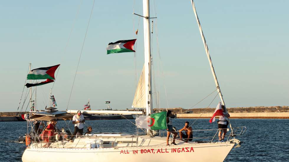 epa12374643 Flags fly aboard a boat of the Global Sumud Flotilla (GSF) before its departure from the port of Bizerte, northern Tunisia, 13 September 2025. The GSF flotilla is an international maritime initiative that began sailing in August 2025 en route to Gaza, aiming to break the Israeli blockade and deliver vital aid to the Gaza Strip.  EPA/MOHAMED MESSARA