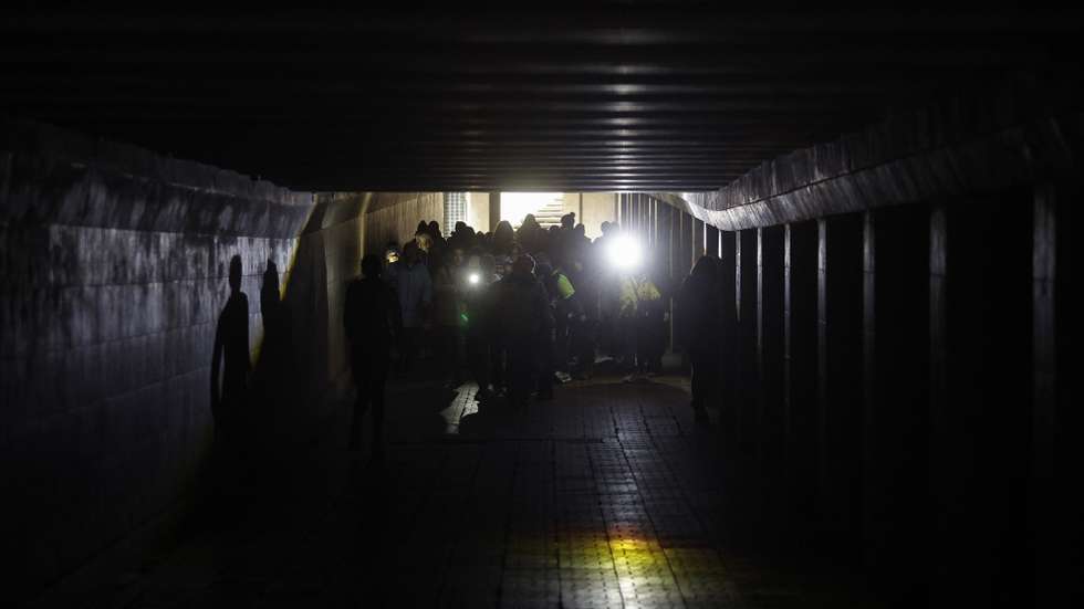 epa12583147 A group of children walks with flashlights in the dark underground crossing during the electricity cut-off in downtown Kyiv, Ukraine, 10 December 2025, amid the ongoing Russian invasion. Most Ukrainian regions are facing the necessity to cut off the power for fourteen to sixteen hours per day after the Russian shelling of gas and electric infrastructure, according to the National Power Company Ukrenergo.  EPA/SERGEY DOLZHENKO