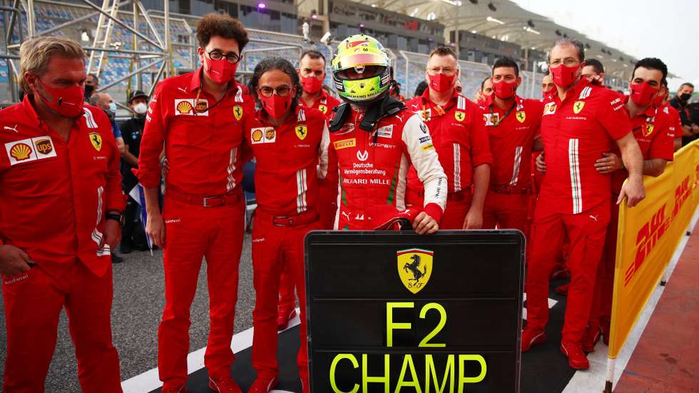 epa08866423 A handout photo made available by the FIA shows German Formula 2 driver Mick Schumacher (C) of Prema Powerteam celebrating winning the F2 title after the Round 12 Sakhir Sprint Race of the Formula 2 Championship at Bahrain International Circuit near Manama, Bahrain, 06 December 2020.  EPA/Joe Portlock  / FIA/F1 HANDOUT  HANDOUT EDITORIAL USE ONLY/NO SALES HANDOUT EDITORIAL USE ONLY/NO SALES *** Local Caption *** BAHRAIN, BAHRAIN - NOVEMBER 26: <<enter caption here>> during previews ahead of the F1 Grand Prix of Bahrain at Bahrain International Circuit on November 26, 2020 in Bahrain, Bahrain. (Photo by Rudy Carezzevoli/Getty Images)