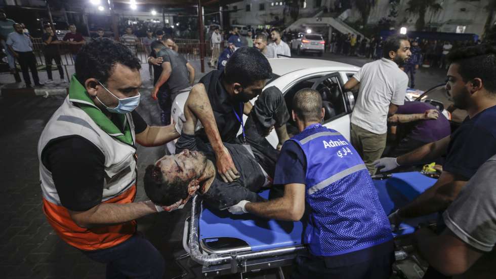 epaselect epa10910966 Palestinians carry a wounded man at Al-Shifa hospital in Gaza City, 10 October 2023. More than 900 Israelis and over 700 Palestinians have been killed and thousands more injured since the conflict escalated on 07 October, when the militant group Hamas launched an unprecedented attack on Israel from the Gaza Strip. Israeli Defense Minister Yoav Gallant on 09 October ordered a 'complete siege' of Gaza, cutting off electricity, food, water and fuel to the Palestinian enclave as Israeli retaliation strikes continued to hit Hamas targets.  EPA/HAITHAM IMAD