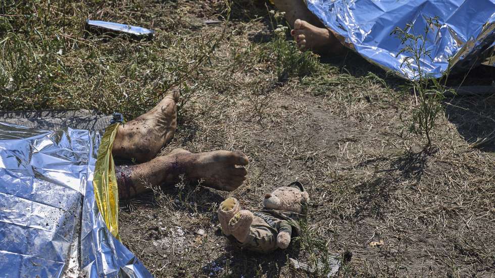 epa13177501 The bodies of victims lie at the site of a Russian missile strike in the village of Pechenihy, Kharkiv region, Ukraine, 18 August 2026, amid the Russian invasion. At least 10 people were killed and 18 others injured in the Russian attack, according to the State Emergency Service.  EPA/SERGEY KOZLOV ATTENTION: GRAPHIC CONTENT