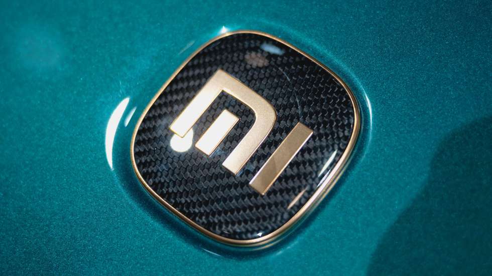 epa12054104 A Xiaomi logo on a car on display at the booth of Chinese technology company Xiaomi during the first public day of the Shanghai Auto show, in Shanghai, China, 25 April 2025. The 21st Shanghai International Automobile Industry Exhibition will be held from 23 April to 02 May. Shanghai Auto will feature over 70 automakers and 100 new models.  EPA/ALEX PLAVEVSKI
