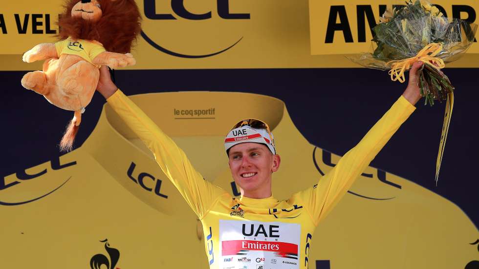 epa09337650 Slovenian rider Tadej Pogacar of the UAE-Team Emirates celebrates on the podium after retaining the overall leader's yellow jersey following the 15th stage of the Tour de France 2021 over 191.3 km from Ceret, France to Andorra la Vella, Andorra, 11 July 2021.  EPA/CHRISTOPHE PETIT-TESSON