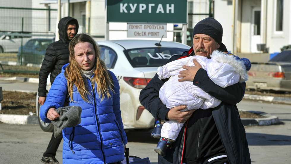 epa09774730 Local residents of the self-proclaimed Donetsk People's Republic cross Russia-Ukraine border on the customs post â€˜Matveev Kurganâ€™ on Rostov region, Russia, 20 February 2022. The head of the self-proclaimed Donetsk People's Republic, Denis Pushilin, announced a general mobilization. The OSCE Special Monitoring Mission has recorded a sharp increase in the intensity of shelling in the Donbas in recent days.  Authorities of the DPR and LPR announced the evacuation of women and children to the Rostov region of the Russia due to the rising tensions in the region.  EPA/ARKADY BUDNITSKY