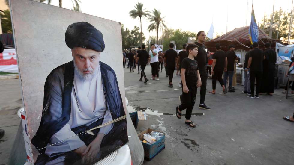 epa10114940 Supporters of Iraqi Shiite cleric Muqtada al-Sadr, head of the Sadrist movement walk next to the Iraqi parliament building, Baghdad, Iraq, 10 August 2022. Sadrist Movement leader Muqtada al-Sadr called on the Iraqi judiciary to dissolve the parliament by the 'end of next week' and task the president with setting early parliament elections. Thousends of the al-Sadr followers stormed the Iraqi parliament building in the heavily fortified Green Zone, home to government buildings and foreign embassies in Baghdad on 31 July 2022.  EPA/AHMED JALIL