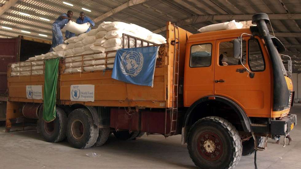 epa000249259 A truck with food sporting the logo of the World Food Program pictured in Benghazi, Libya, on 12 August 2004. The UN's World Food Program last month reached what officials called a 'landmark' agreement with Libya to allow ships to dock at the Mediterranean Sea port of Benghazi and for trucks to haul the goods south through the desert to Chad and Darfur, where 1.2 million black Africans have fled attacks by the militias.  EPA/SABRI ELMHEDWI