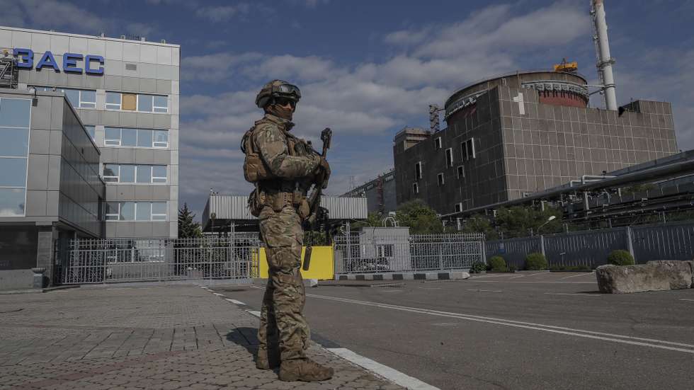 epa09921718 A picture taken during a visit to Mariupol organized by the Russian military shows Russian serviceman on guard in front of the  Zaporizhzhia Nuclear Power Station in Enerhodar, southeastern Ukraine,  01 May 2022. The Zaporizhzhia Nuclear Power Station is under control of the Russian National Guard, the Ukrainian military that guarded the facility handed over their weapons and were released on 09 March according to Andriy Shevchik, head of the Enerhodar city administration. On 24 February Russian troops entered Ukrainian territory in what the Russian president declared a 'special military operation', resulting in fighting and destruction in the country, a huge flow of refugees, and multiple sanctions against Russia.  EPA/SERGEI ILNITSKY