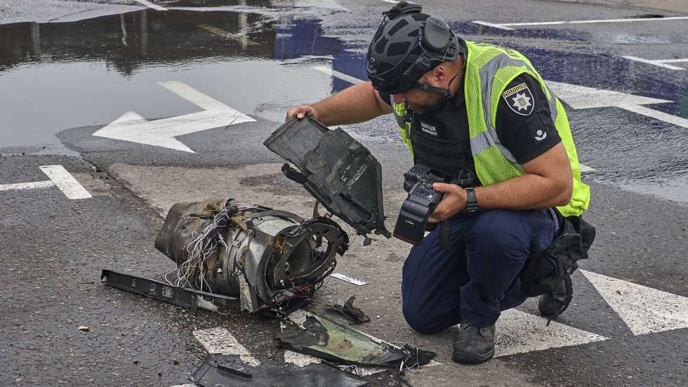 epa13194893 An expert invesigate an engine of a Russian drone at the site of a Russian strike on a shopping mall in Kharkiv, Ukraine, 27 August 2026, amid the Russian invasion. At least one person died, and five others were injured during a drone attack on a construction hypermarket in Kharkiv, according to the Ukrainian State Emergency Service (SES).  EPA/SERGEY KOZLOV