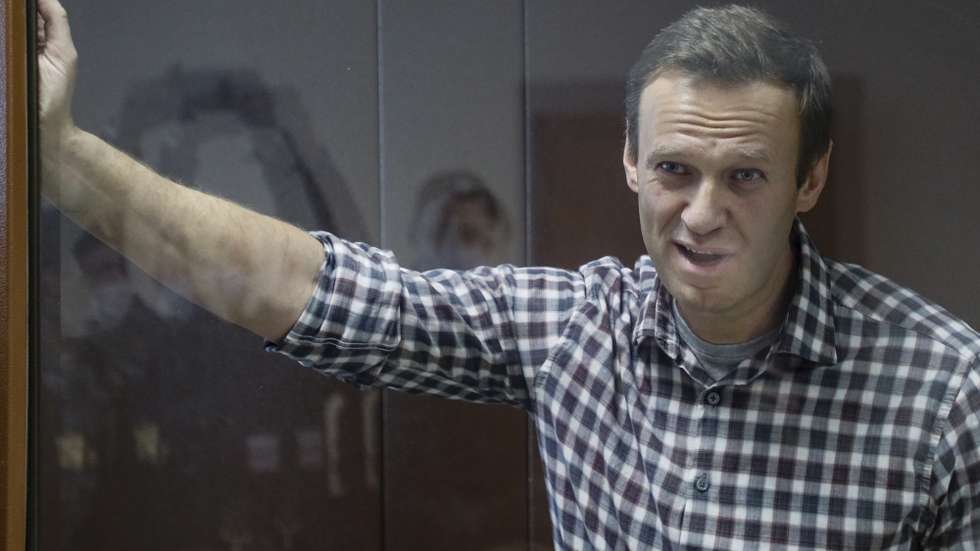 epa09025250 Russian opposition leader Alexei Navalny stands inside a glass cage prior to a hearing at the Babushkinsky District Court in Moscow, Russia, 20 February 2021. The Moscow City court will hold a visiting session at the Babushkinsky District Court Building to consider Navalny's lawyers appeal against a court verdict issued on 02 February 2021, to replace the suspended sentence issued to Navalny in the Yves Rocher embezzlement case with an actual term in a penal colony.  EPA/YURI KOCHETKOV MANDATORY CREDIT