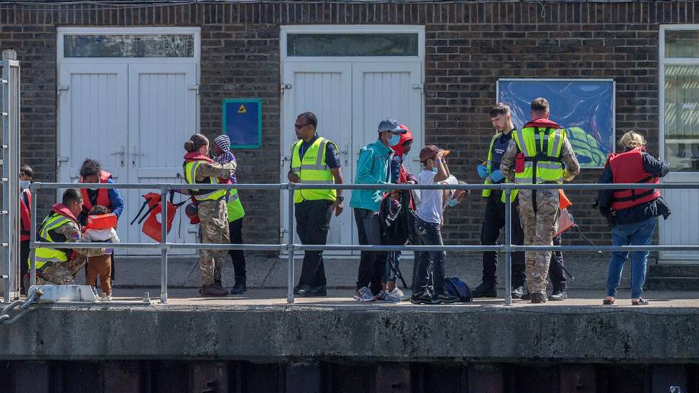 epa10105604 Migrants after disembarking a Border Force Volunteer rescue boat, which has escorted 90 migrants after they were picked up in the English Channel, Dover, Britain, 04 August 2022. A report from the United Nations High Commissioner for Refugees and the British Red Cross has found that critical gaps in the UK asylum system may result in people being at risk of potential exploitation when they arrive in the UK.  EPA/STUART BROCK
