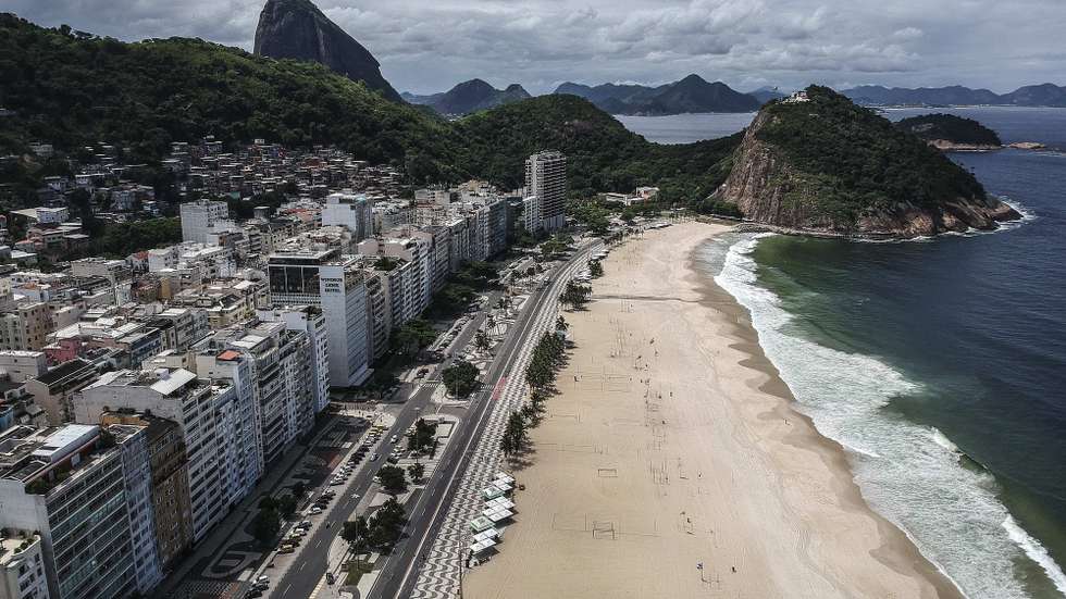 epa08319185 An aerial taken with a drone showing the beach of Leme, empty due to restrictive measures to prevent the spread of the coronavirus in Rio de Janeiro, Brazil, 24 March 2020. All shops in Rio De Janeiro are closed except for supermarkets and pharmacies, in an attempt by the authorities to further restrict measures to prevent the spread of the coronavirus. Brazil has nearly 1,900 people infected with COVID-19 and 34 deaths.  EPA/Antonio Lacerda